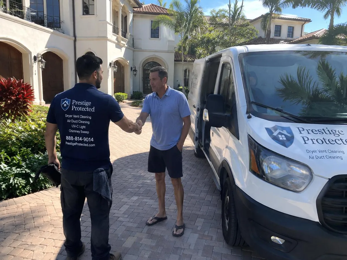 Prestige Protected technician greeting a homeowner before an air duct cleaning in Boca Raton, FL