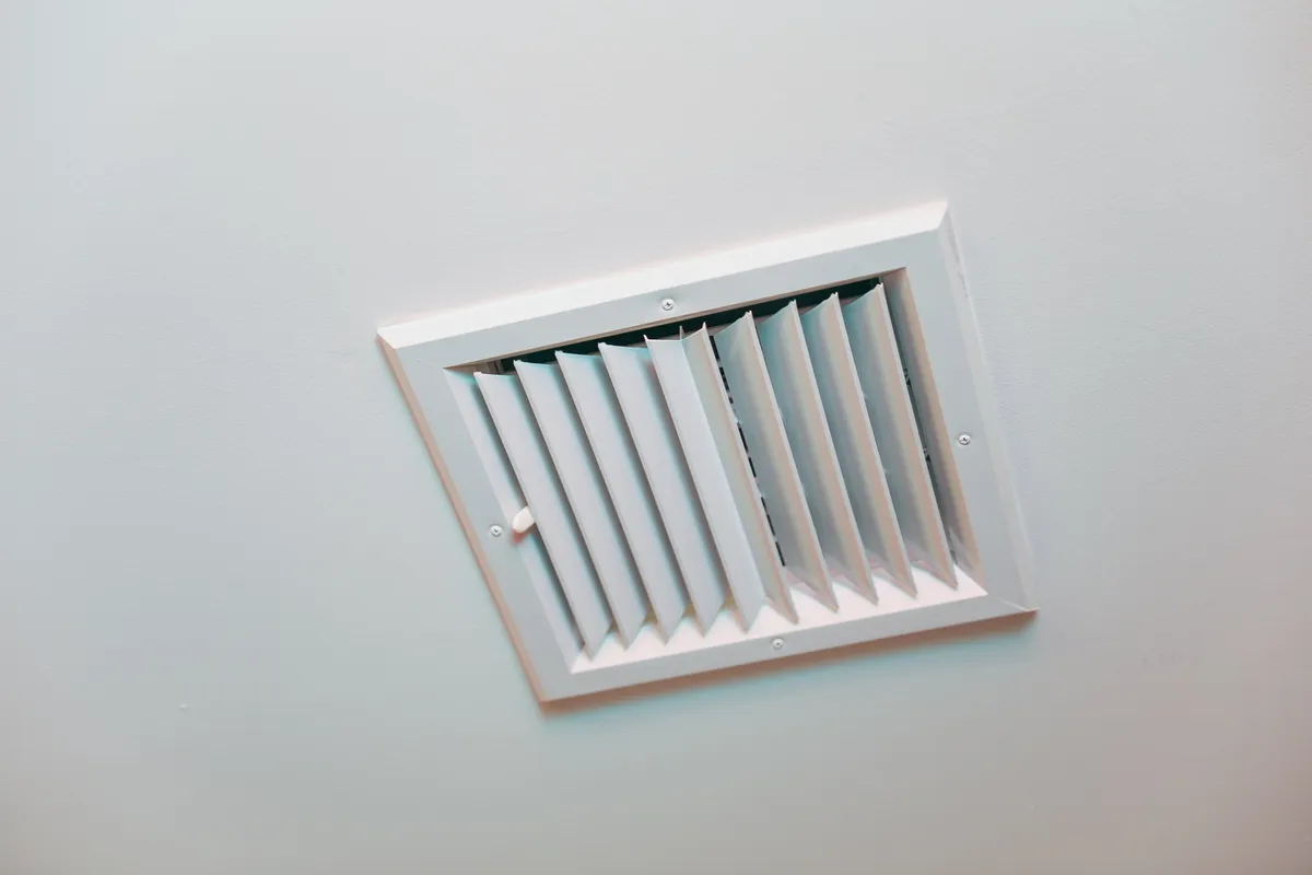 Closeup of clean metal ductwork in a modern air ventilation system, highlighting the importance of air duct cleaning.